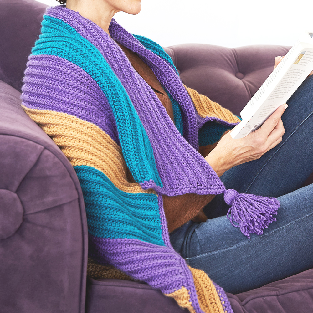 The Bright Stripe Blanket is one of a kind with its vibrant stripes and decorative tassels, you’re sure to have some fun adventures if you take this blanket along. #crochetblanket #crochetafghan #crochetpattern #crochetlove #crochetaddict
