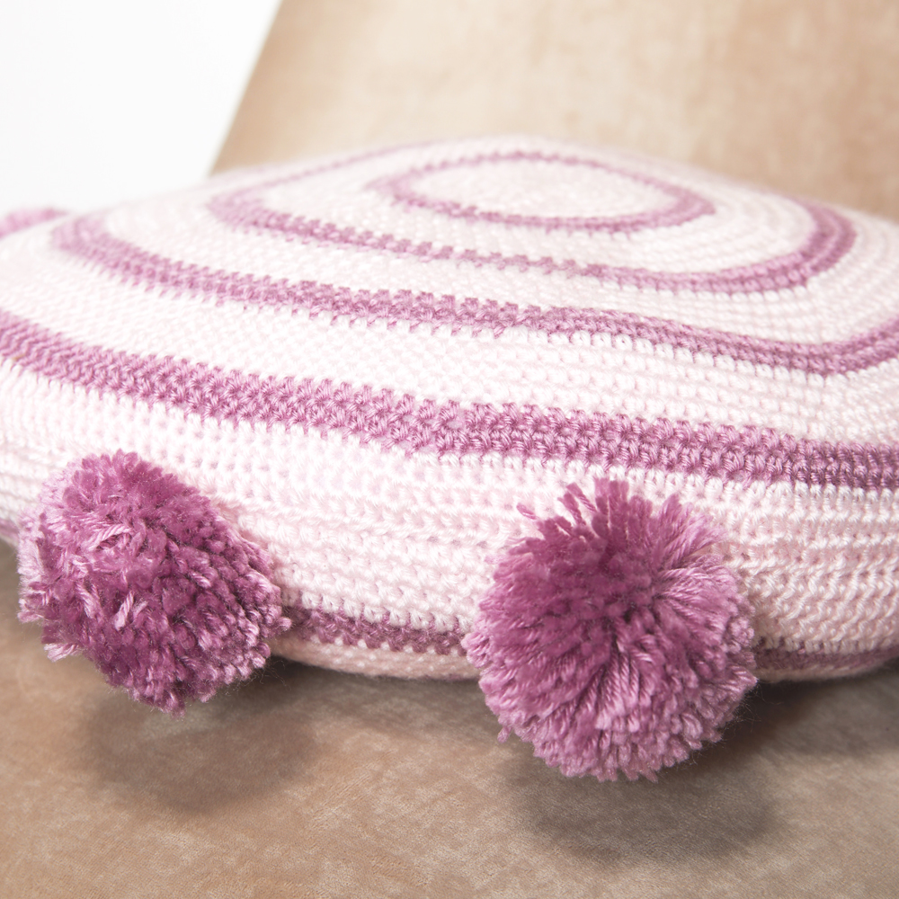 This Pom Pom Cushion makes an absolutely wonderful housewarming gift or statement piece for your home. #crochetcushion #crochetpillow #crochetpattern #crochetlove #crochetaddict