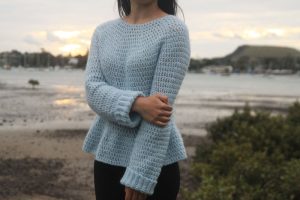 Julia Peplum Crochet Sweater - These 16 super easy crochet sweater patterns are the best we’ve found. There’s a good variety to choose from whether you like them light, cropped or with a classic look. #easycrochetsweaterpatters #easycrochetpatterns #crochetsweaters