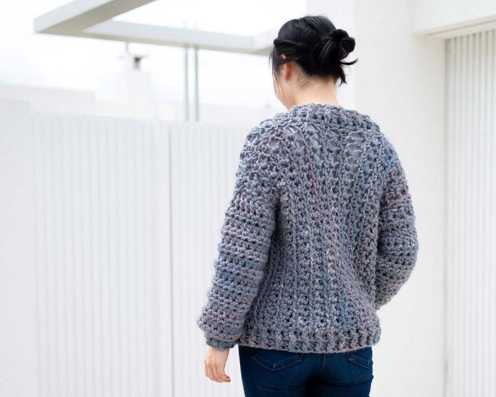 Woman wearing chunky crochet bomber cardigan