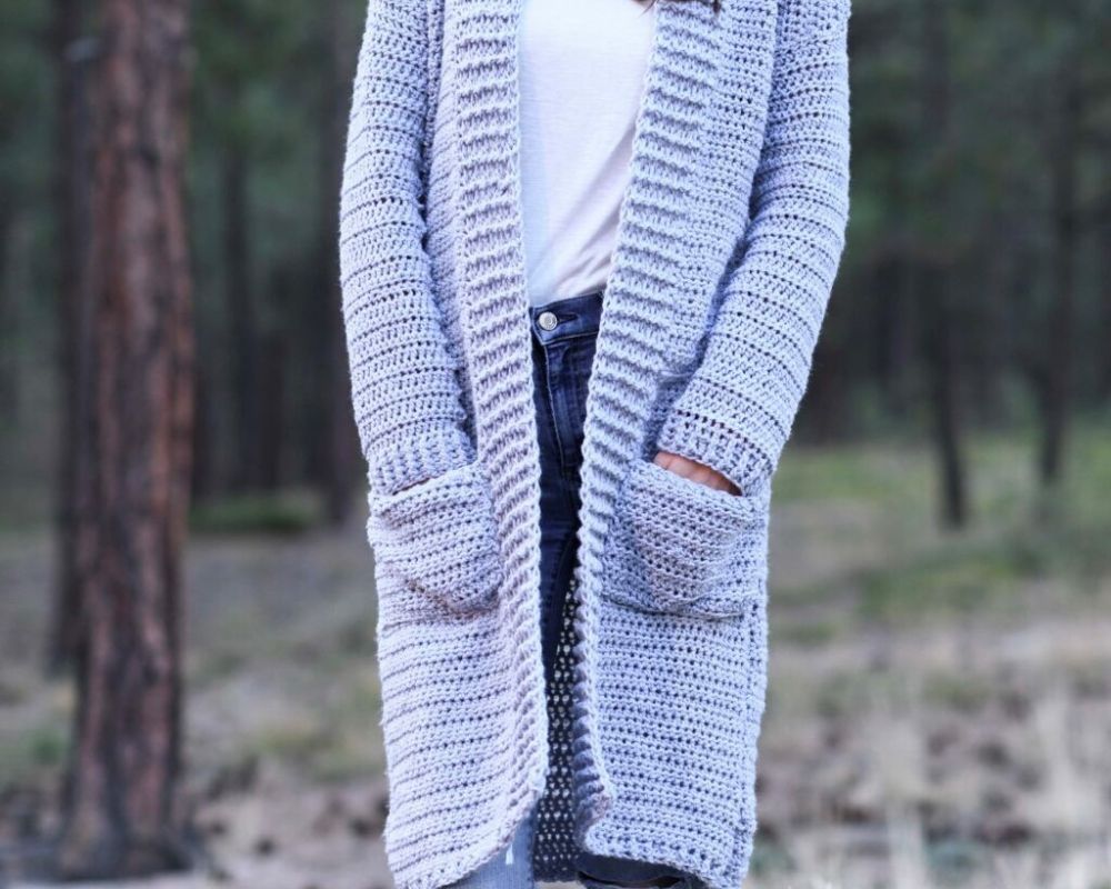 Woman wearing long autumn duster cardigan with pockets