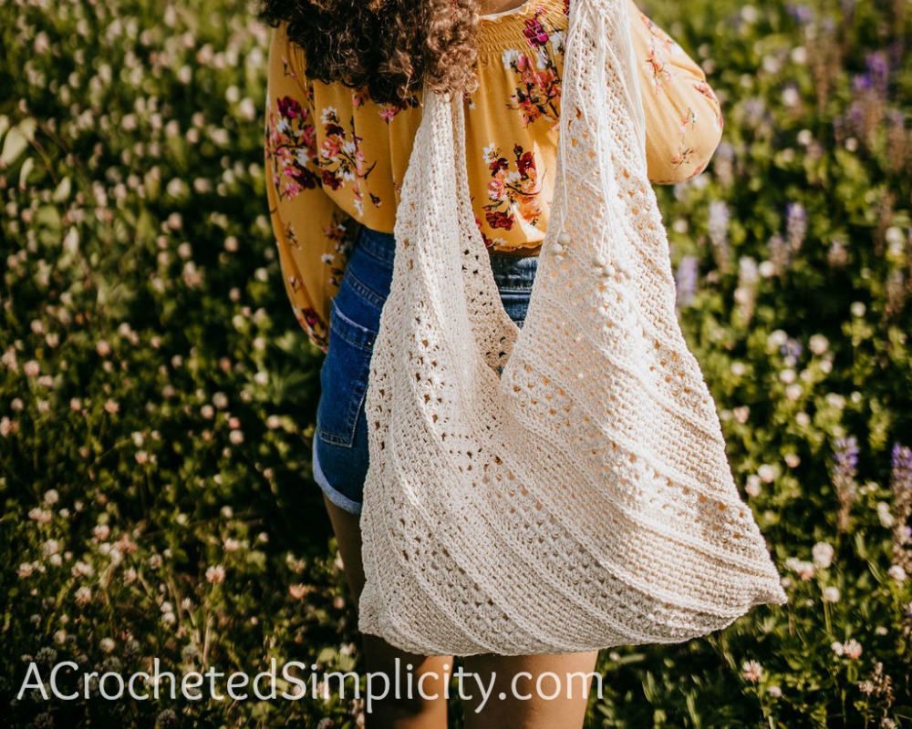 A girl holding the On the Bias Crochet Tote Bag
