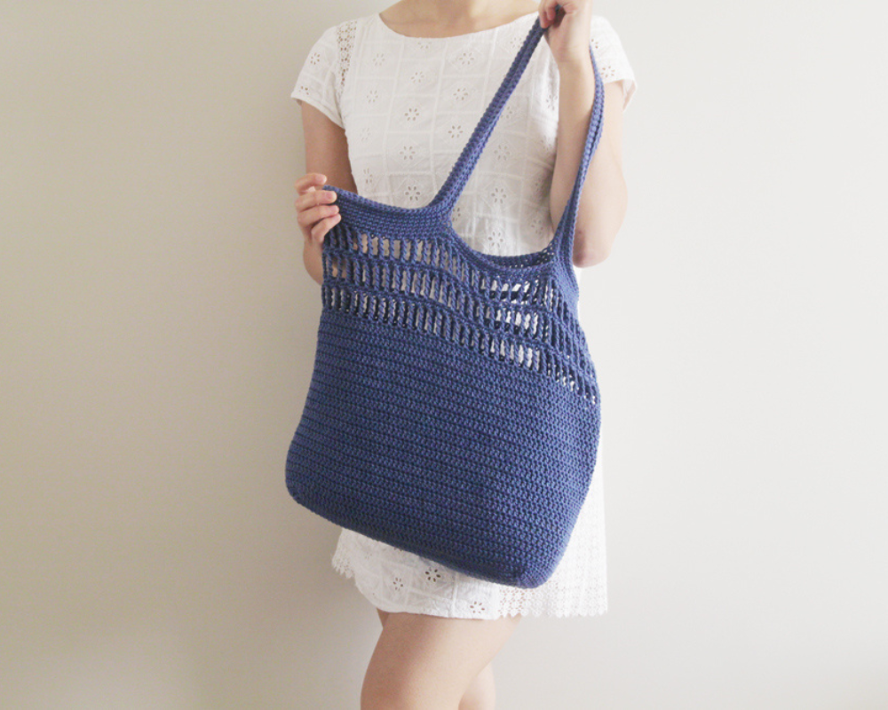 A woman holding the Easy Market Crochet Tote Bag