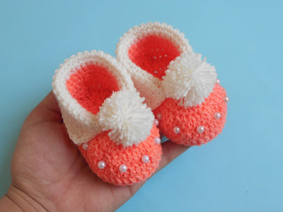 person holding crochet cuffed baby booties