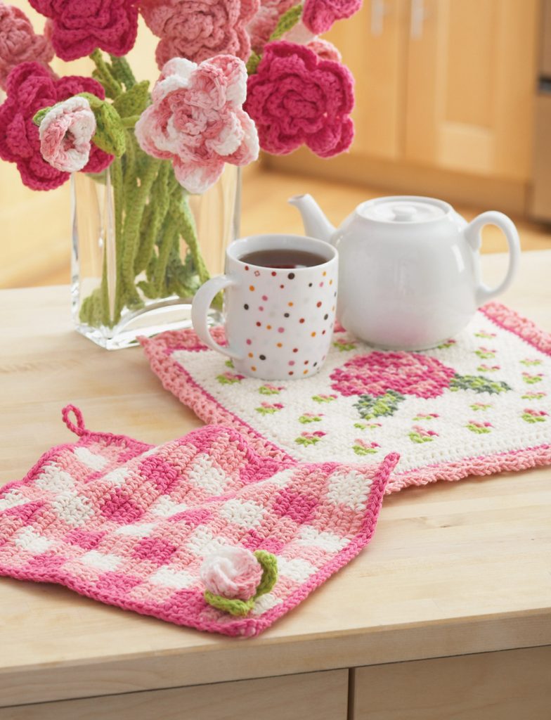 The Gingham Crochet Dishcloth beside a coffee and a flower base